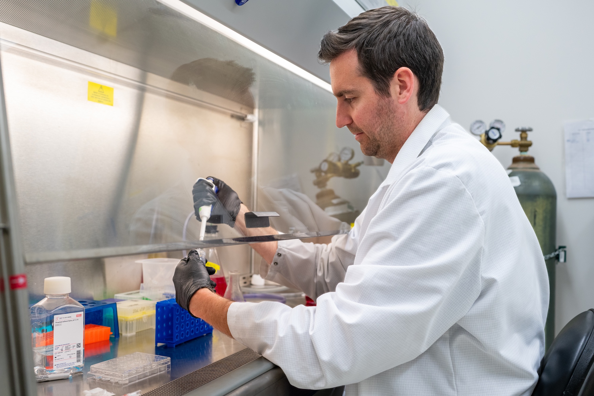 Michael Byron of the Innovation Lab working under a hood bench