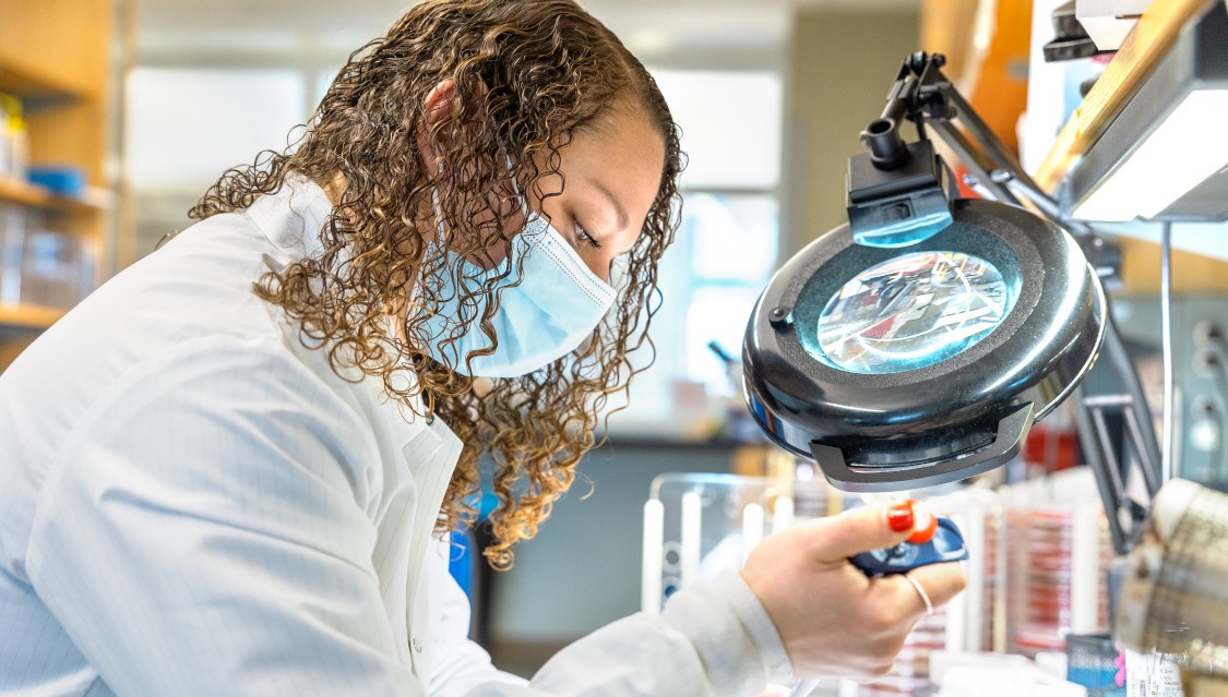 Student with with various lab equipments