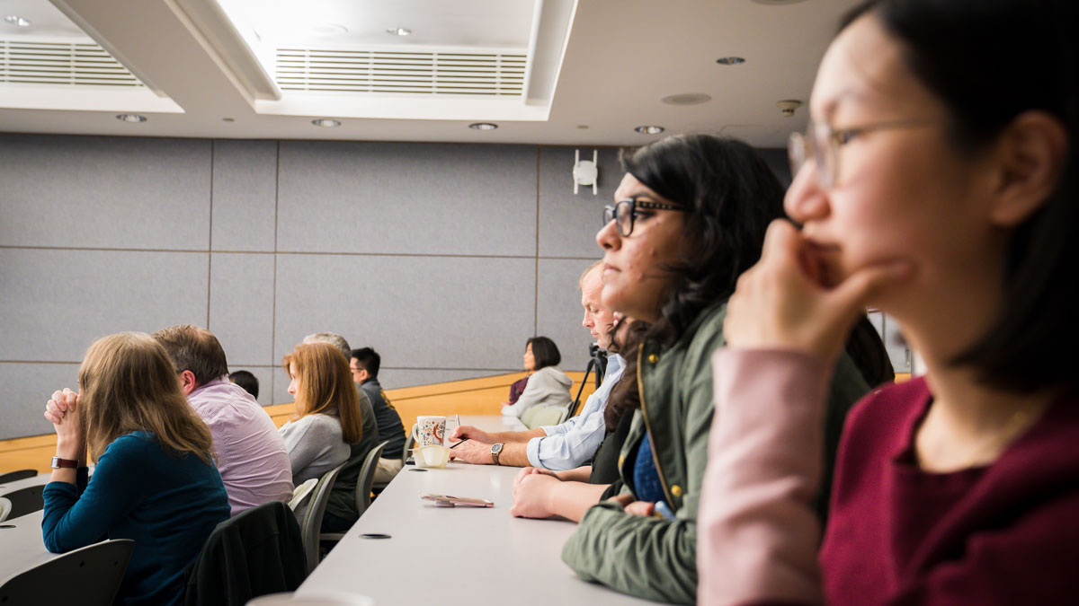 A group of people observe a presentation at the 2019 Zweig event