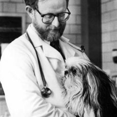 Dr. William Hornbuckle holding a dog, 1987