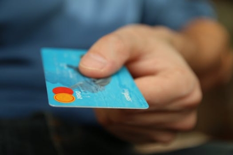 Stock photo of a hand holding a credit card