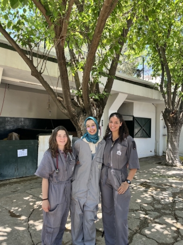 Whittington standing with two colleagues outside of a building