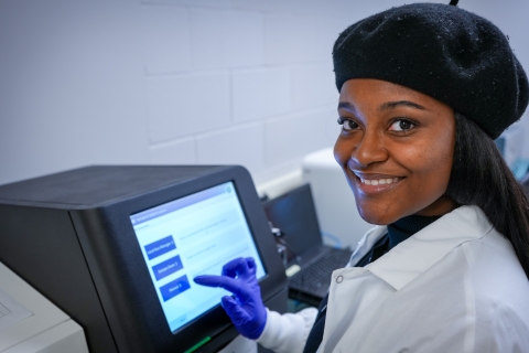 A student works at a machine in the west wing of the Baker Institute. 