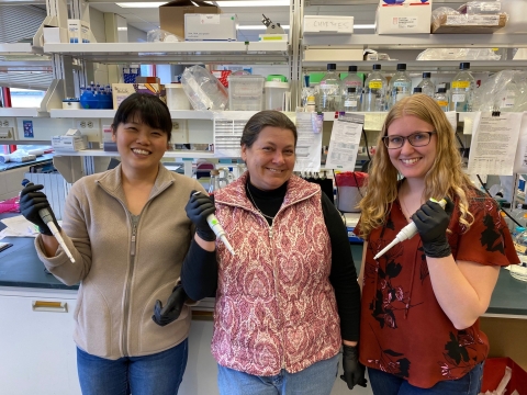 Three women working in a lab at the Baker Institute. 