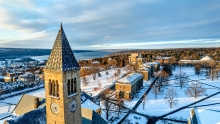 Aerial of the Cornell tower in winter overlooking Cayuga Lake