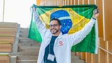 Igor Muller holding a Brazilian flag over his head