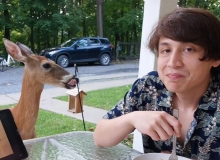 Sebastian Soto with a deer to the left of the image