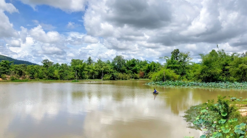 small boat on a large tropical river