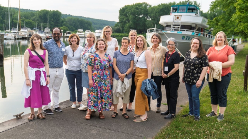 Group of conference goers standing at a marina