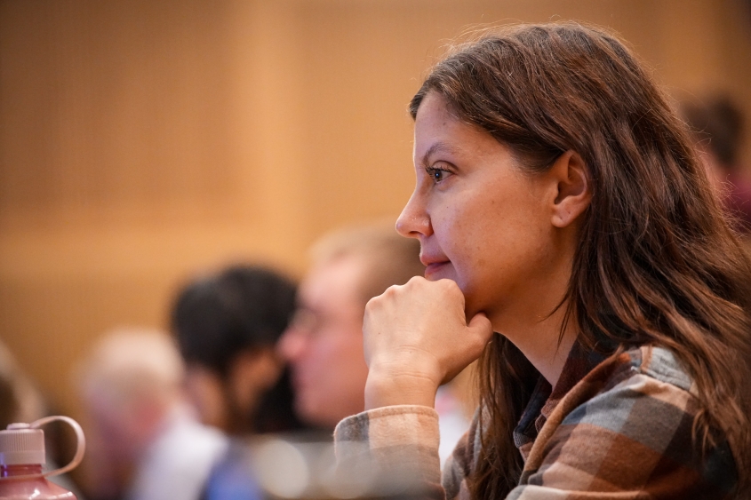 An attendee at the Fred Scott Feline Symposium looks on during a lecture session. 