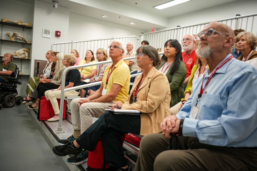 A group of attendees at the Fred Scott Feline Symposium enjoy a presentation inside the necropsy lab. 