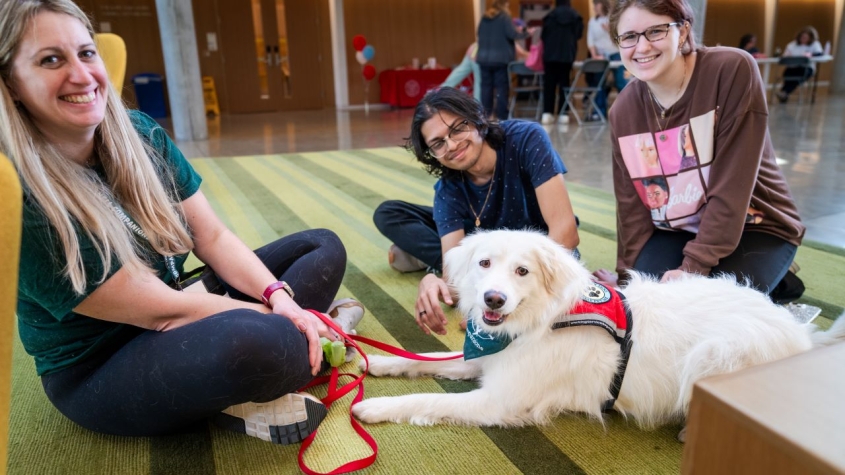 students with white fluffy dog