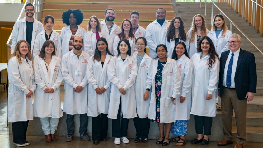 Group photo of students in white lab coat