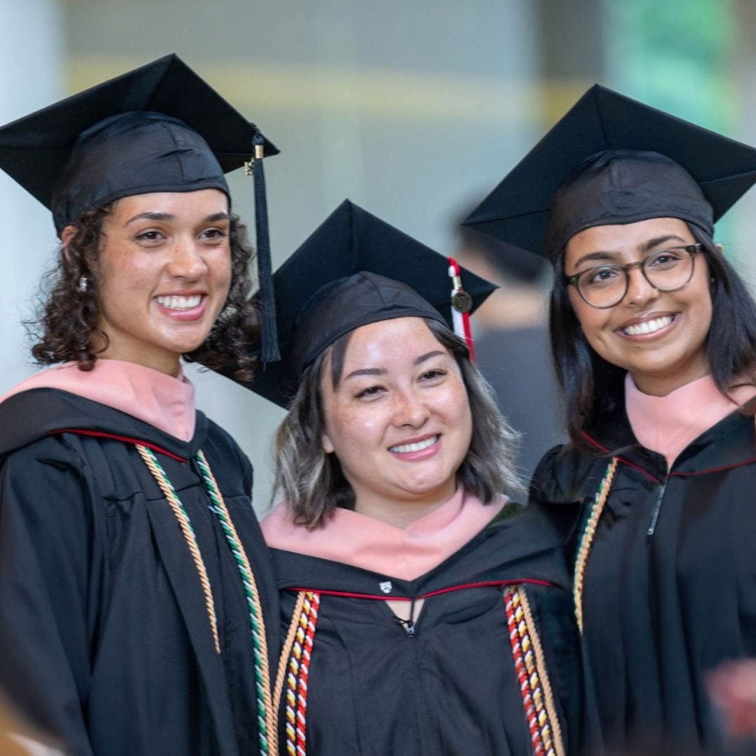 3 MPH alumni smiling at graduation