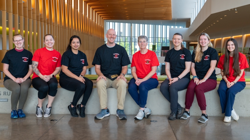 The Sports Medicine team seated in the atrium with Remington t-shirts on