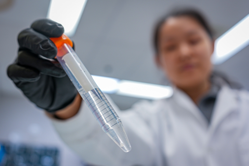 A researcher holding a sample tube 