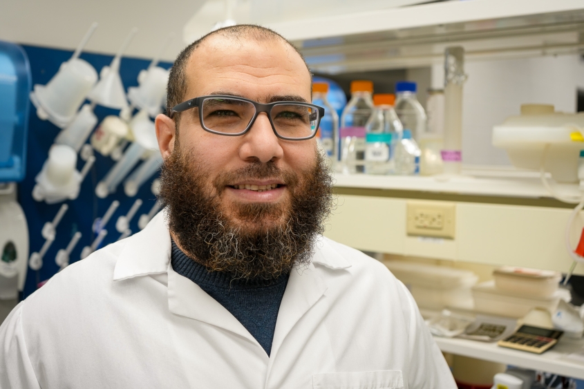 Photo of Dr Shebl Salem wearing a white lab coat inside the de Mestre Lab at the Baker Institute.