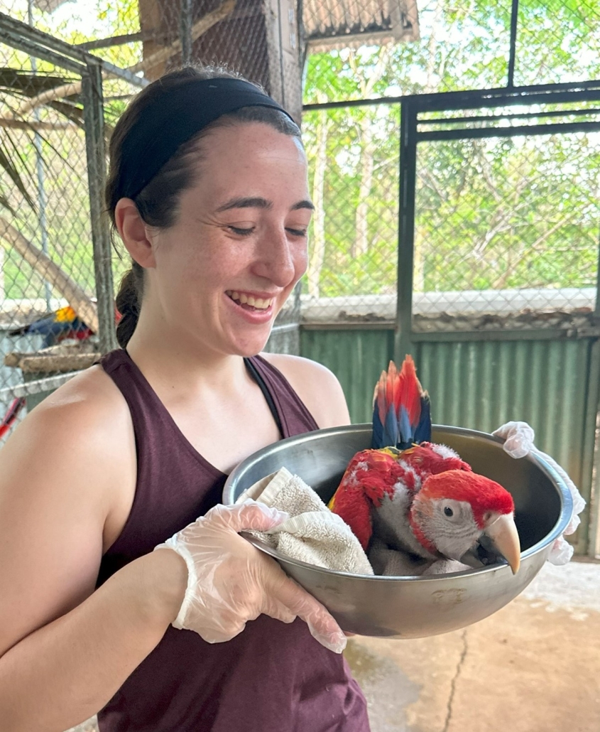 Marta Bakaj and parrot chick