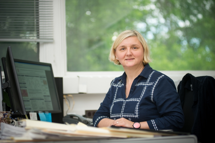 Renata Ivanek sitting at a desk in front of a window